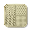 A beige silicone lick mat for dogs and cats with suction cups, featuring various textured patterns.