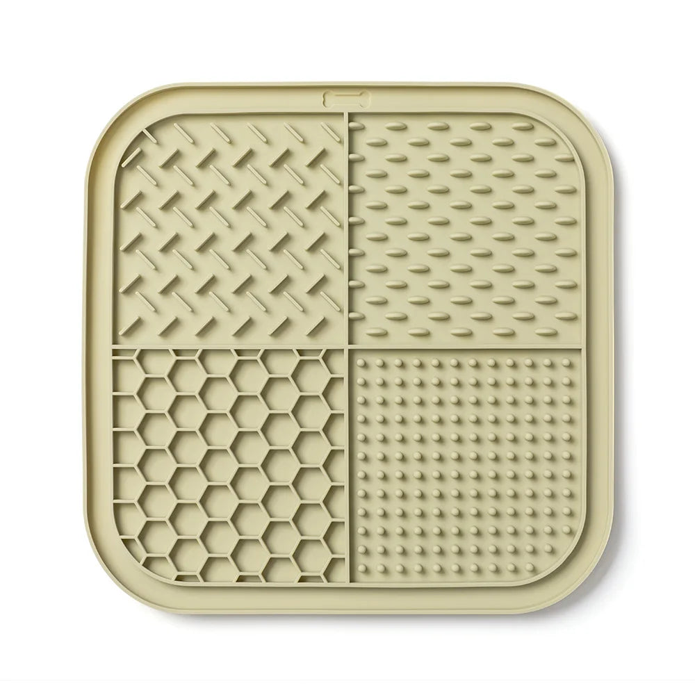 A beige silicone lick mat for dogs and cats with suction cups, featuring various textured patterns.