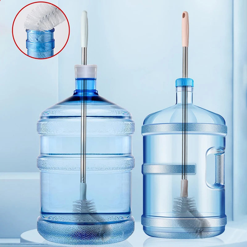 A clear plastic water bottle filled with liquid and a stainless steel cleaning brush is shown on a white surface.
