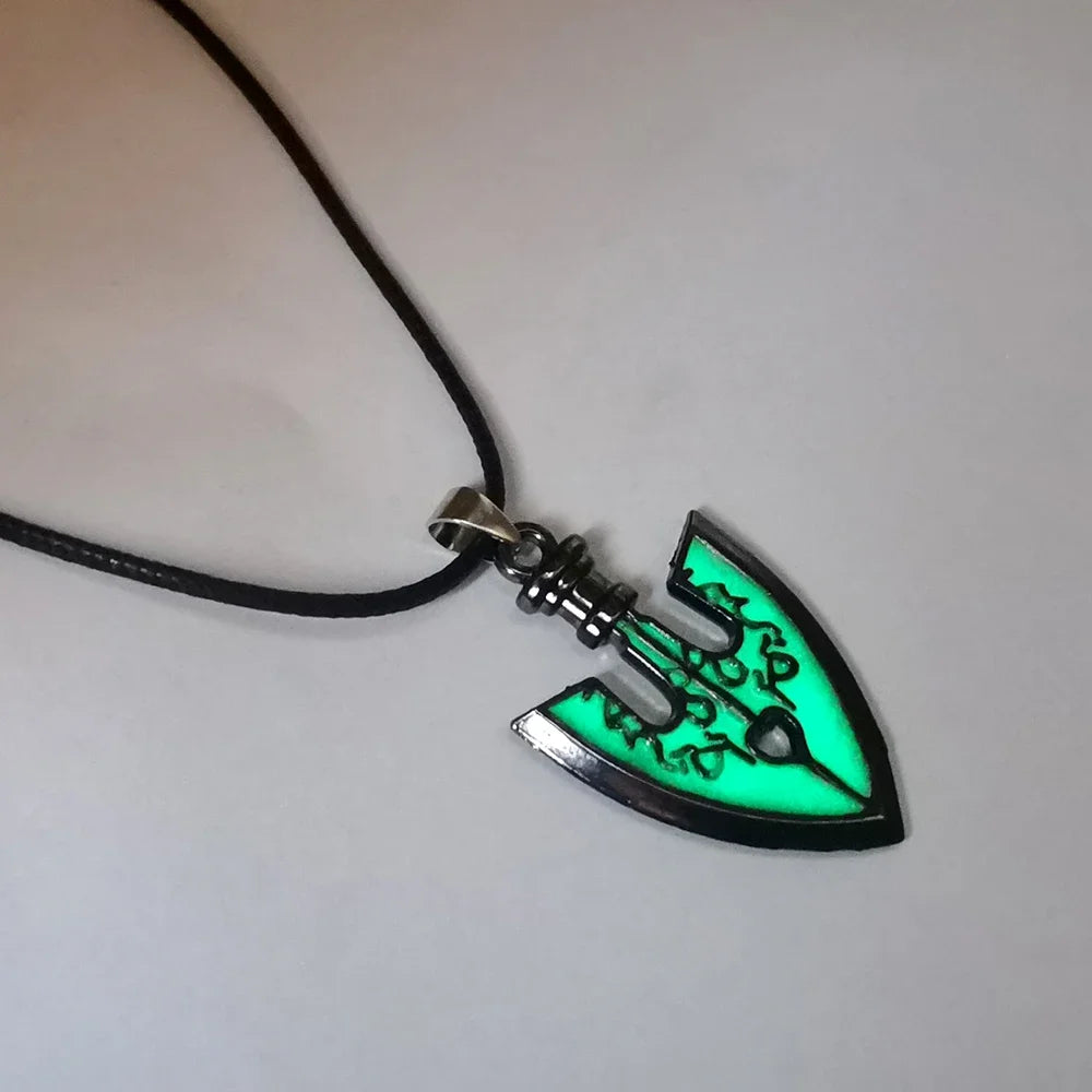 A pendant necklace featuring a green glowing stone shaped like a sword on a silver-colored chain.