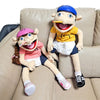 A plush toy of Jeffy featuring a blue hat and yellow shirt sitting on a light brown couch.