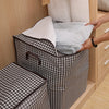 A brown and white checkered quilt storage bag is shown being placed into a wooden cabinet.