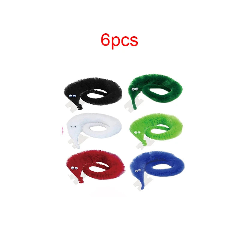 Six fuzzy wiggly worm magic trick props in black, green, white, and blue colors