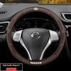 Brown leather steering wheel cover for a Nissan vehicle interior.