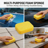 A set of yellow multi-purpose foam sponges being used for car washing, waxing, grout cleaning, and household chores.