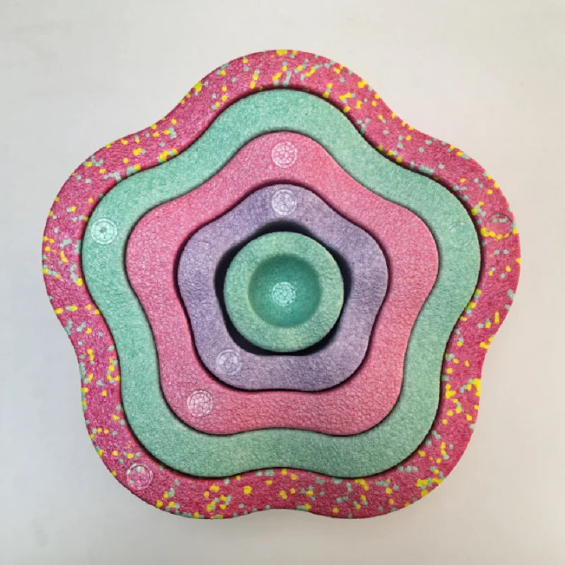 A colorful, multi-layered plastic stepping stone designed for sensory and motor skill development.
