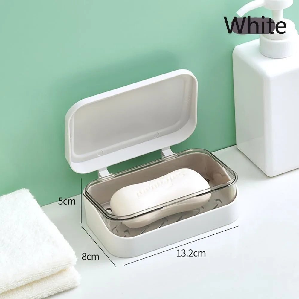 White transparent soap dish with a drainage tray and lid shown on a white surface.