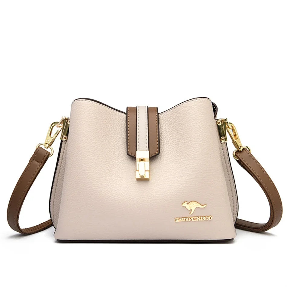A light beige leather shoulder bag with gold hardware and a brown strap.