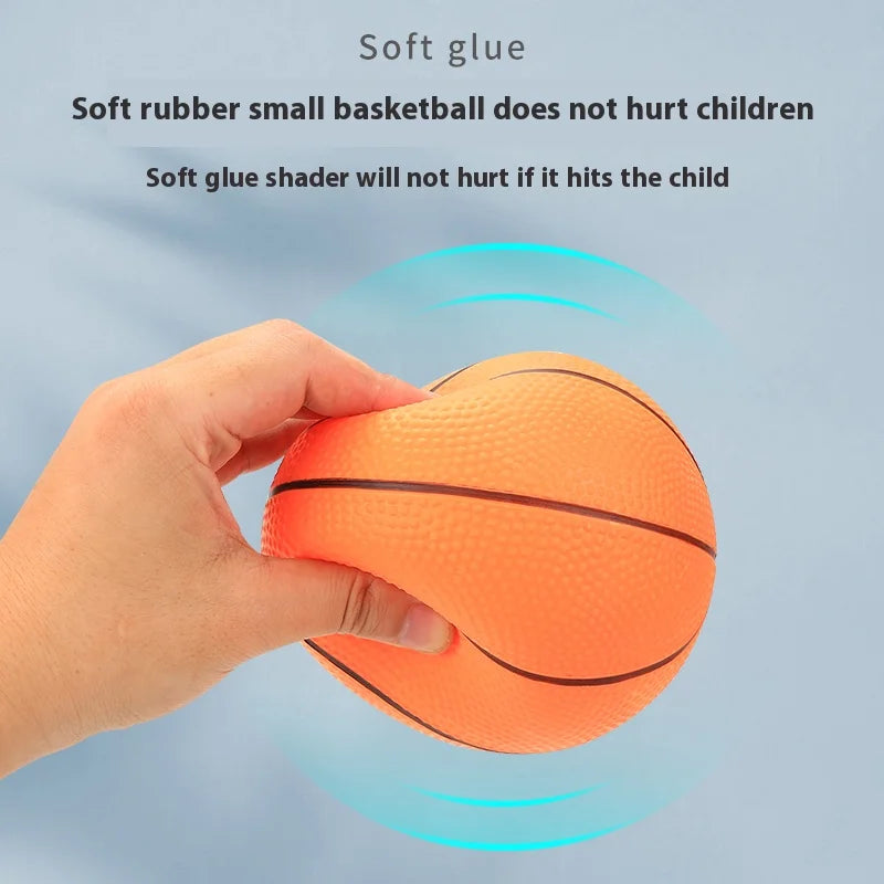 A hand is holding an orange basketball, demonstrating the safety of soft glue shader for children.