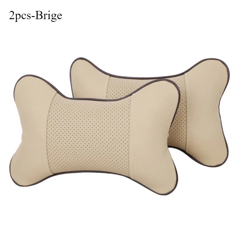 Two beige leather knitted car neck pillows with a stitched pattern.