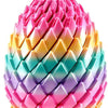 A colorful, textured fidget egg toy with pink, yellow, blue, and purple segments.