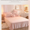 A pink plush mink velvet duvet cover set displayed on a bed with light pink pillows and a decorative lamp.