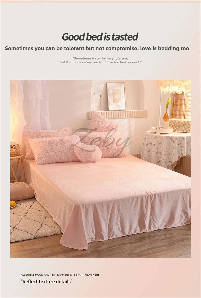A pink plush mink velvet duvet cover set displayed on a bed with light pink pillows and a decorative lamp.