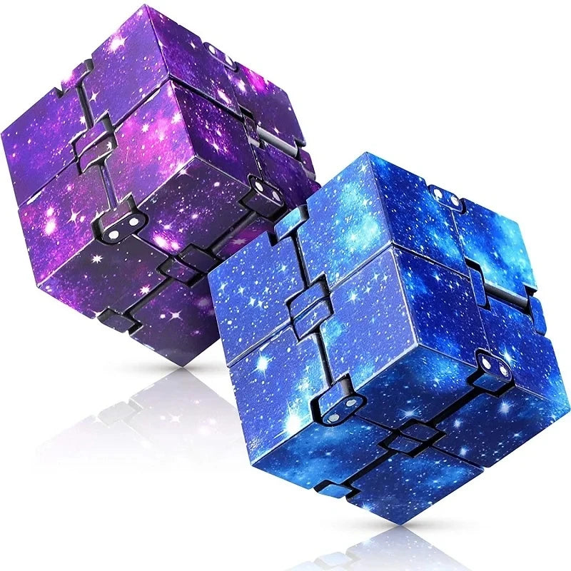 Three purple and blue cosmic foam stress balls stacked and displayed on a reflective surface.