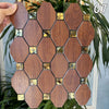 A collection of brown wooden mosaic tiles with gold accents arranged in a geometric pattern.