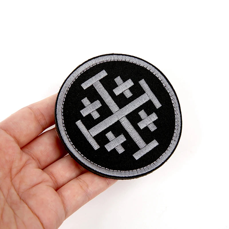 Black embroidered patch featuring a silver Knights Templar cross design with hook and loop backing