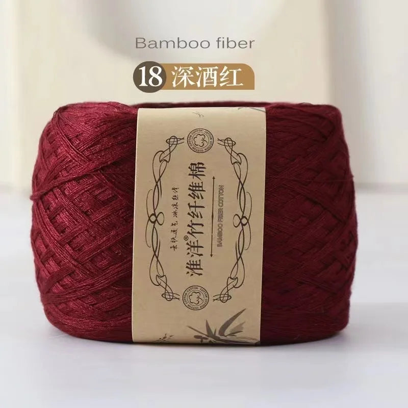 A ball of deep red bamboo fiber yarn for knitting and crochet