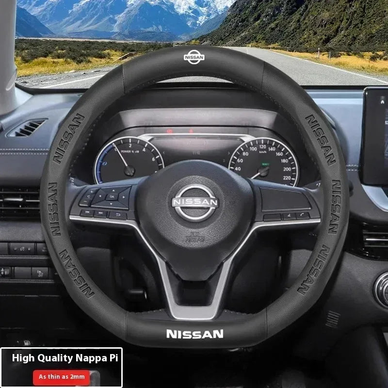 Interior view of a Nissan steering wheel with carbon fiber trim and sport design.