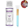 A bottle of Diamond Painting sealer with a gold applicator brush and a small sample of the glossy finish.