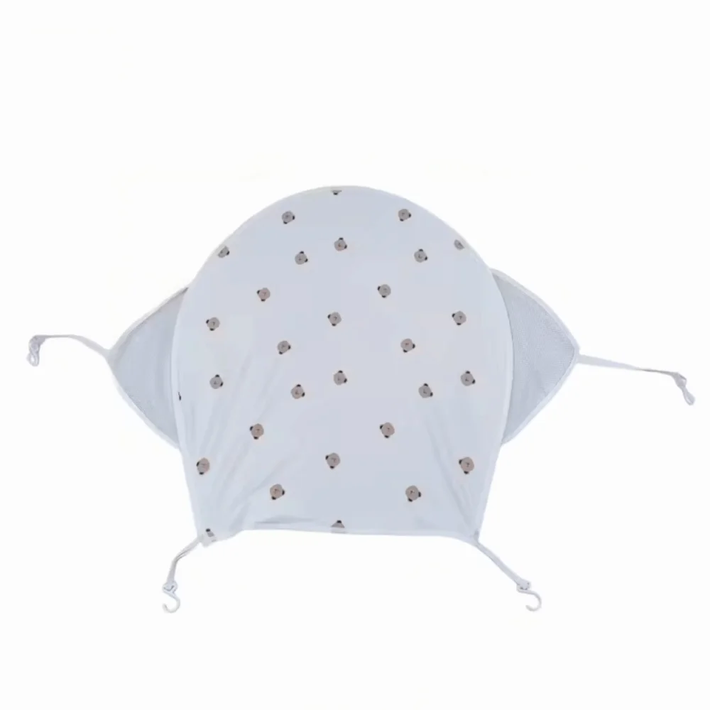 White stretchable UV-protective stroller sun shade with a dotted pattern