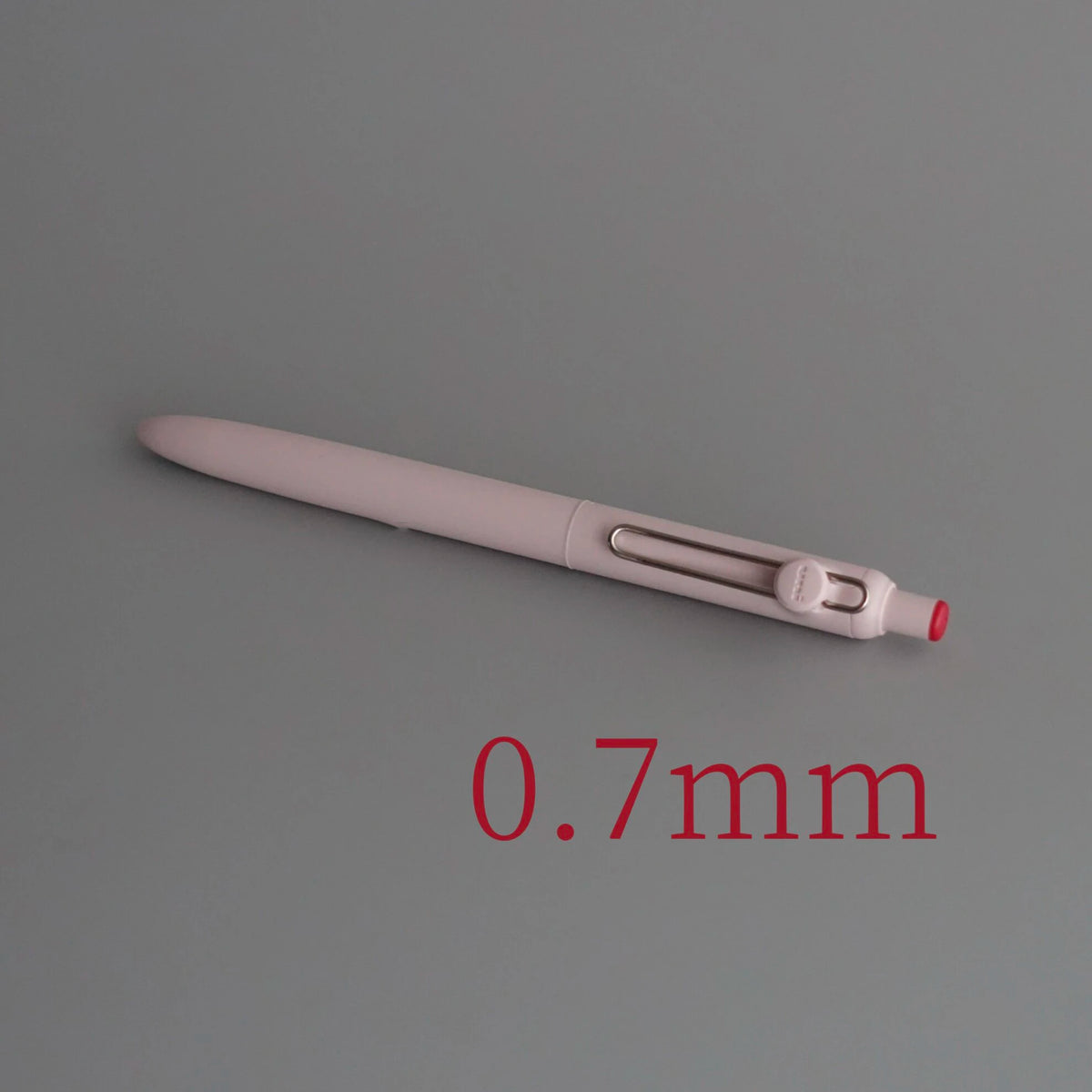 A close-up view of a light pink Uni ZENTO Quick-Dry Gel Pen with a 0.7mm tip.