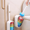 A wall-mounted disposable toilet cleaning kit with a handle and refillable cartridges is shown next to a toilet.
