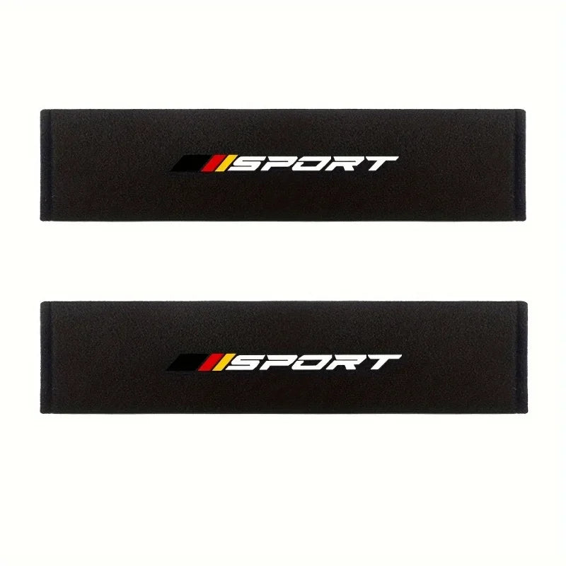 Two black soft car seat belt cushion sets featuring the SPORT logo in yellow and red.
