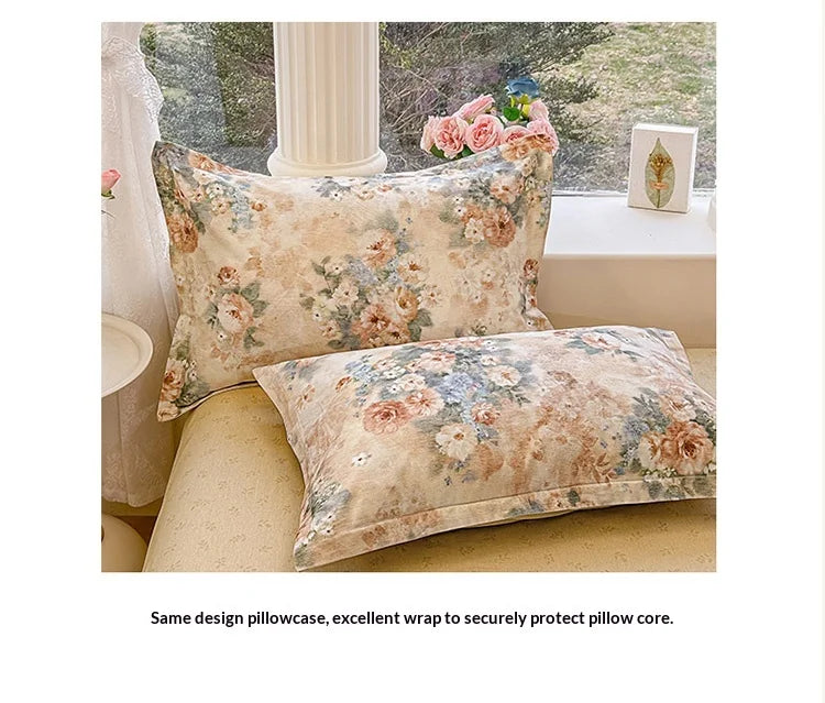 A close-up of a floral patterned pillowcase and duvet cover set in soft beige tones.