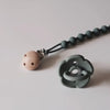 A silicone pacifier clip with a teether is shown against a light background.