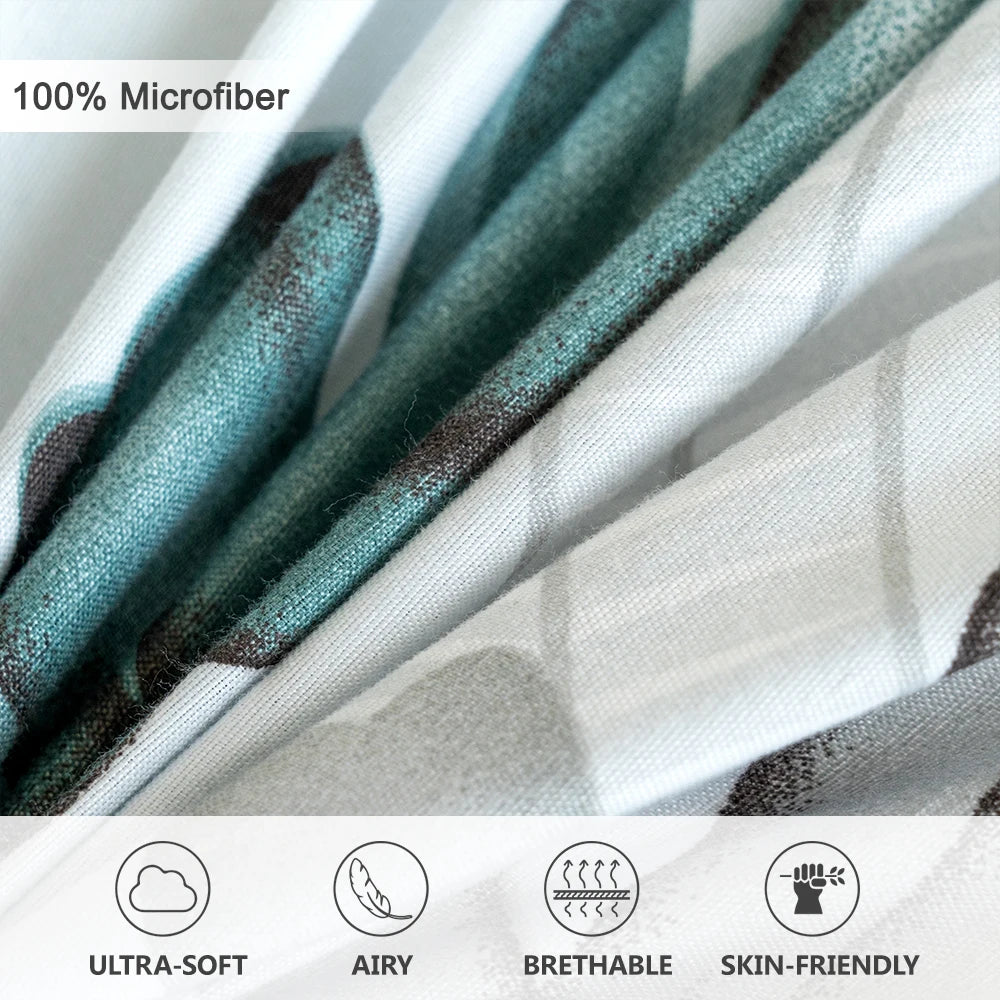 Close-up of a teal and grey watercolor floral microfiber fabric showing its texture and soft drape.