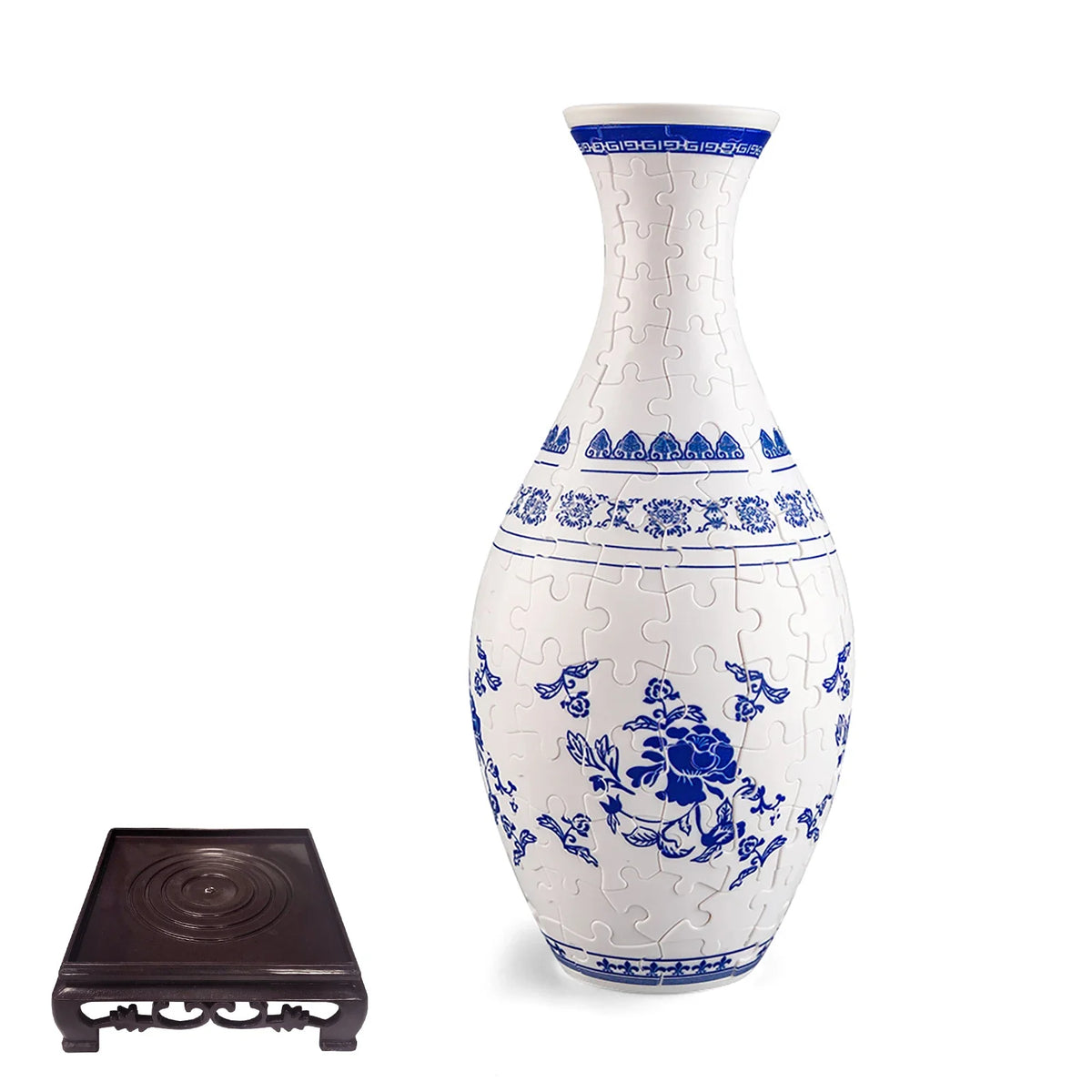 A white ceramic vase with blue floral patterns and a puzzle design, standing on a dark square base.