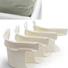 White non-slip sheet fixing clips or straps used for securing bedding.