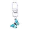 Silver butterfly keychain charm with turquoise blue wings
