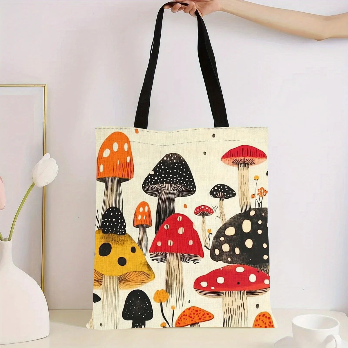 A tote bag featuring a colorful print of various mushrooms on a light background.