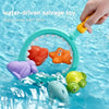 A hand holds a water-driven salvage toy featuring a catch net with orange and purple sea creatures floating in blue water.