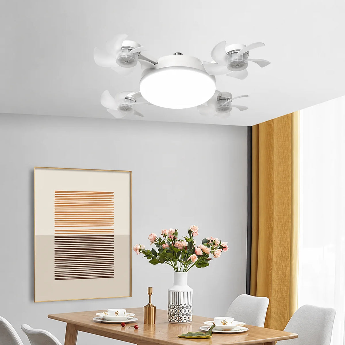 A white LED ceiling fan with multiple lights is mounted on a white ceiling above a wooden table.