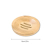 A round natural bamboo soap dish with slatted drainage holes.