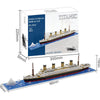 A box and assembled model of the Titanic ship built from building blocks.