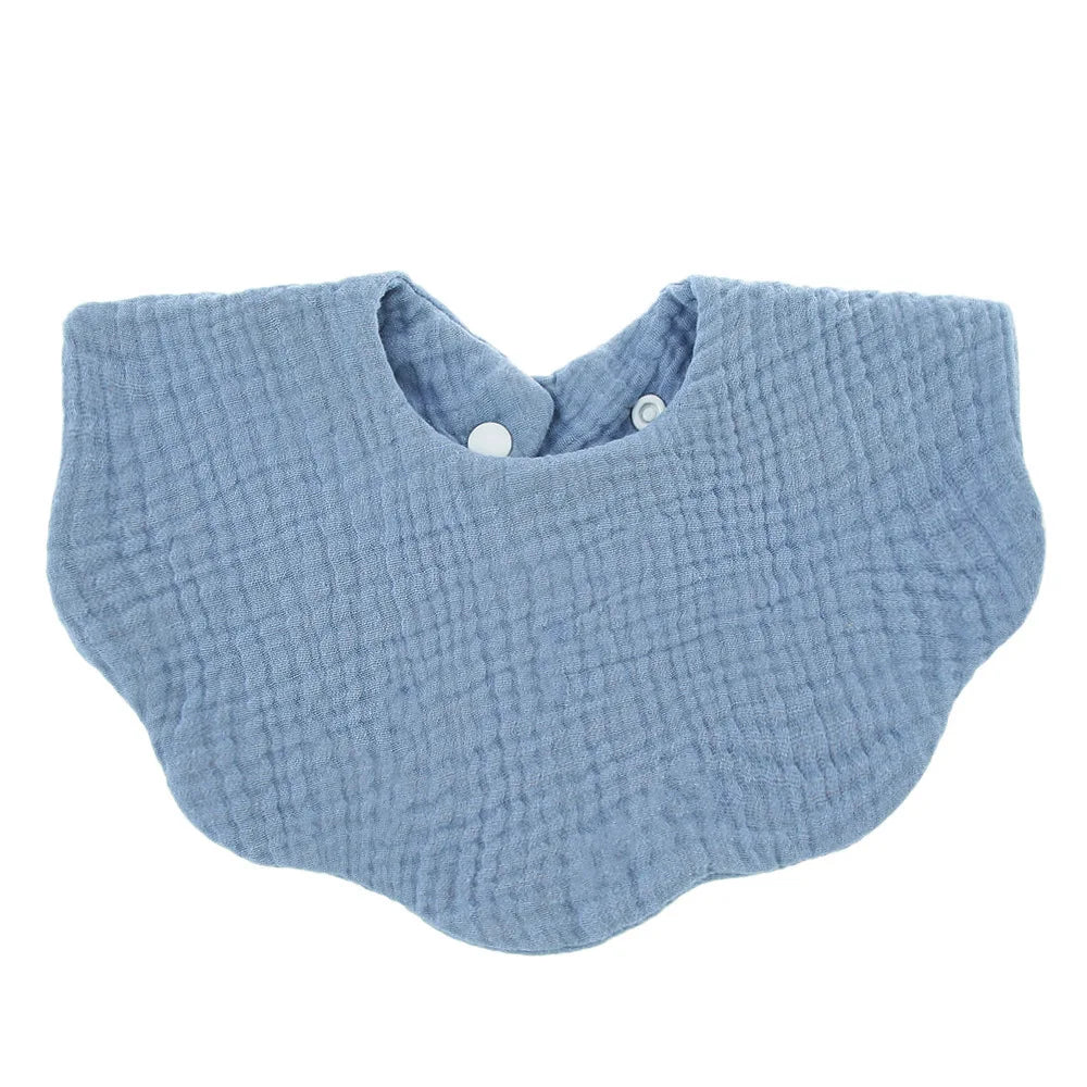 Light blue knitted baby bib in a bandana style with a snap closure