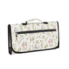 A foldable waterproof baby changing pad with a light floral pattern and a black handle.
