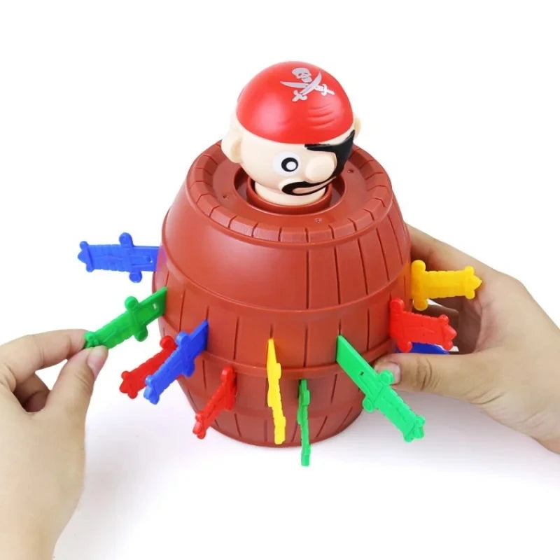 A hand is holding a red plastic pirate figure with a black mustache and a bandana, part of a jumping pirates board game.