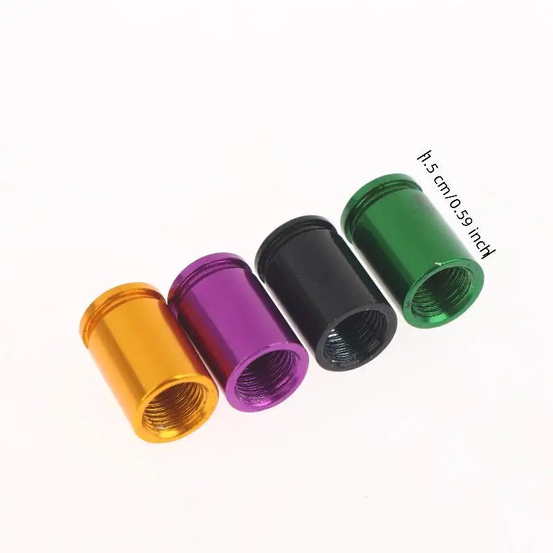 A set of four bullet shell tire valve stem caps in gold, purple, black, and green, shown against a white background.