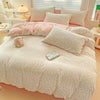 A pink floral duvet cover set with a matching flat sheet and pillows displayed on a bed.
