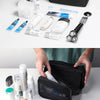 A black waterproof travel bag is shown open, containing various toiletries like toothbrushes, toothpaste, and facial cleanser