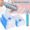 A set of clear vacuum storage bags with blue valves and a hand holding one bag, next to a vertical blue storage bag.