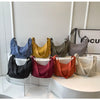 A display of various lightweight nylon crossbody bags in shades of blue, yellow, olive green, gray, maroon, orange, and beige