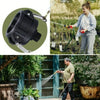 A black IBC tote drain adapter with a 2-inch camlock fitting is shown next to a person using it on a garden hose.