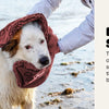 A dog wearing a dirty shammy towel on a beach, with text describing the ultra-soft, fast-drying absorbency of the towel.