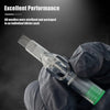 A gloved hand holds a clear tattoo cartridge needle with a green tip and fine wires.