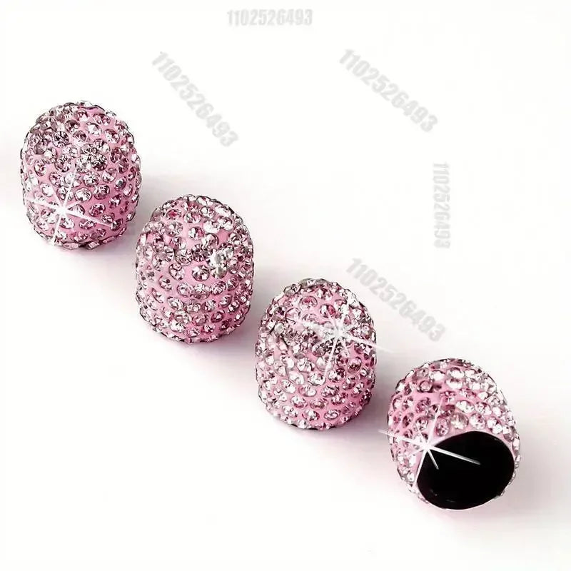 Ein Set rosa Kristall-Diamant-Radventilkappen auf weißem Hintergrund